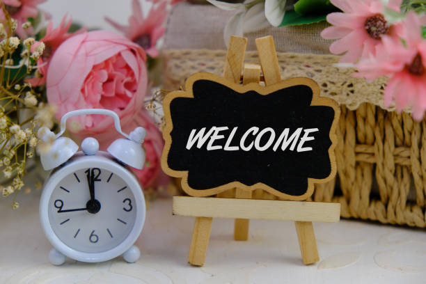 istock text of  WELCOME on board with flowers and alarm clock 2201415963