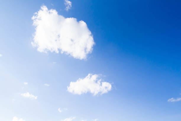White airy beautiful clouds in a bright blue sky. Clear sunny weather. The concept of environmental safety and cleanliness..