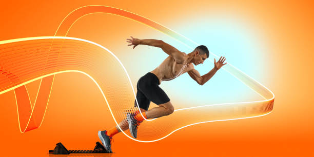 istock Sport collage. Sprinter launching off starting blocks with glowing motion trails following powerful stride against energetic background. 2201424346
