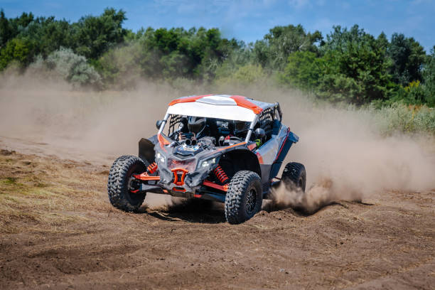 istock UTV buggy, ATV (quad), 4x4 in the action on sand 2201426119