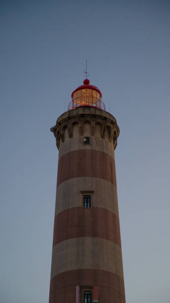 istock Farol do Barra aveiro lighthouse in Aveiro district, standing tall on a cloudy day 2201429340