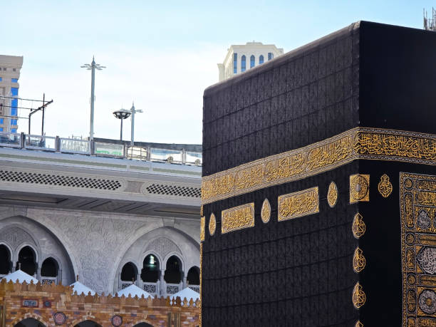 The close up image of Kaaba The photo depicts the shape of a certain part of the Kaaba with a kiswah or black cloth covering it and gold calligraphy embroidery decorating it. sharia stock pictures, royalty-free photos & images