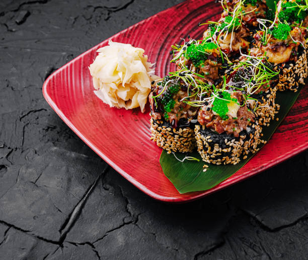 istock Gourmet sushi rolls topped with fresh ingredients set on a stylish plate 2201434248