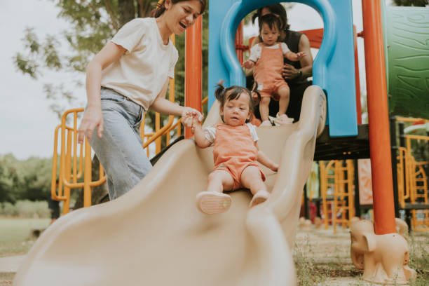 istock Happy Family Bonding at the Park with Twin Daughters 2201434379