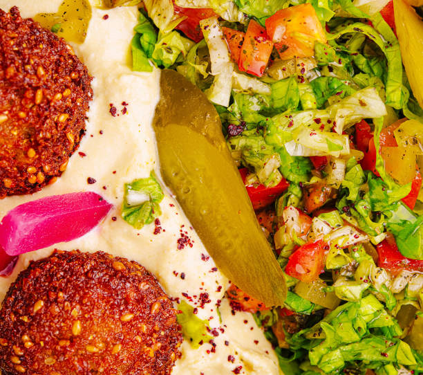 Delicious falafel dish served with fresh vegetables and pickles at a vibrant restaurant