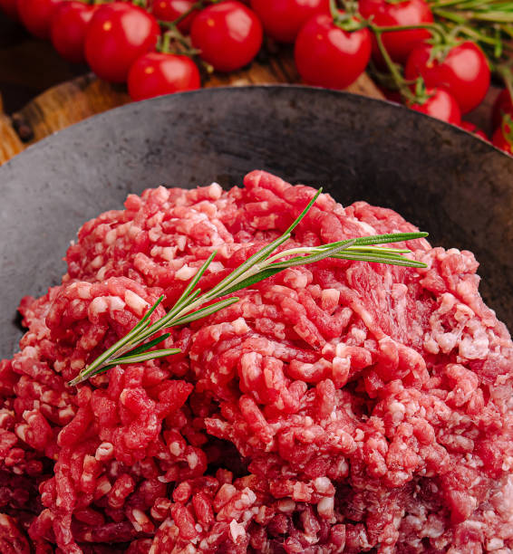 istock Fresh ground beef with herbs and vegetables on rustic wooden table 2201434402