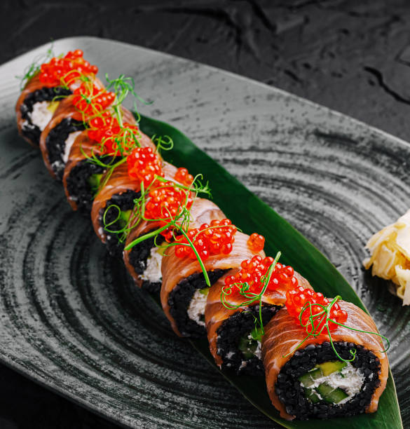 istock Delicious sushi platter presented elegantly on a textured black plate with fresh ingredients and toppings 2201434498