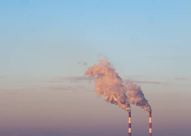 istock smoking chimneys against the blue sky 2201435369