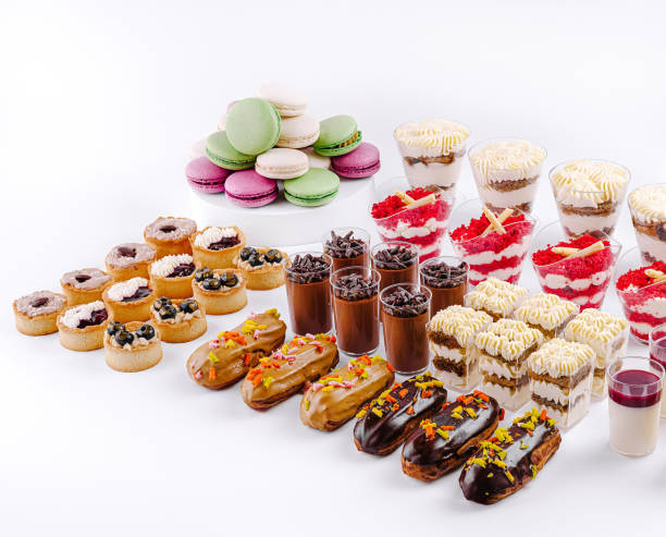 istock Delightful dessert spread featuring layered treats, pastries, and colorful macarons at a festive gathering 2201436990