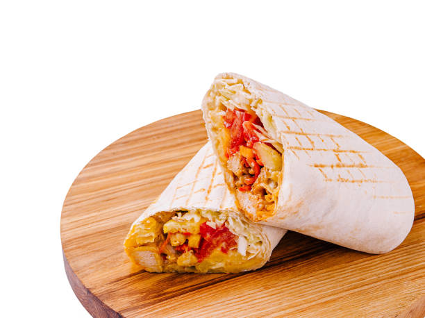 istock Delicious freshly made burrito on a wooden serving board with vibrant fillings 2201437144