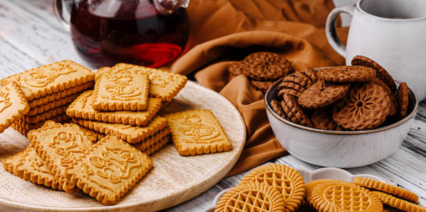 istock Assorted cookies arranged on a rustic wooden table with tea and a cozy atmosphere perfect for sharing 2201437238