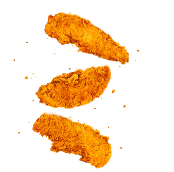 Tasty flying fried chicken strips on isolated white background.