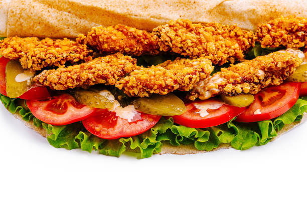 istock Crispy fried chicken sandwich with fresh vegetables on toasted bread served at lunchtime 2201442985