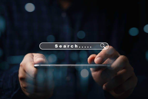 istock Businessman using smartphone with search bar icon for browsing information network and SEO or search engine optimization concept. 2201443516