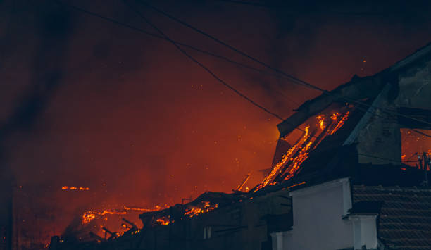 Night time image of a roof engulfed in fire