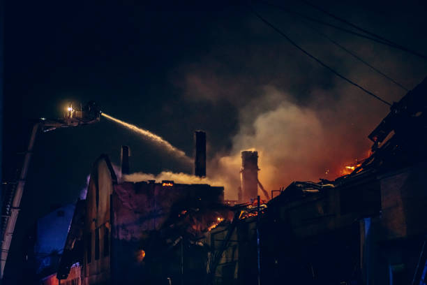 istock Firefighters extinguish a fire in an industrial building during the night 2201444721