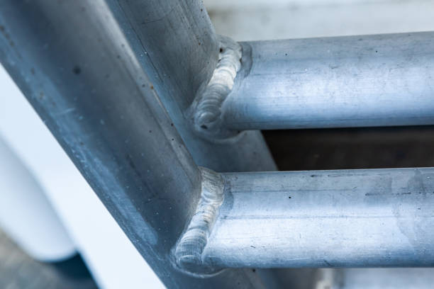 istock Welded aluminum pipes of a round profile, close-up. 2201450117