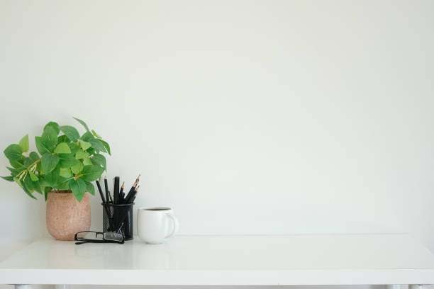 istock Minimalist workspace with a coffee cup, potted plant and pencil holder. Copy space for your text. 2201451266