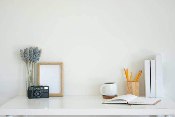 istock Creative workplace with retro camera and lavender flowers, a notebook, coffee mug, and writing supplies. 2201451275
