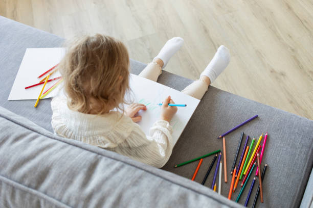 istock Children activity from drawing with colored pencils in album for motor and creativity sensory development. Toddler art therapy. 2201453072