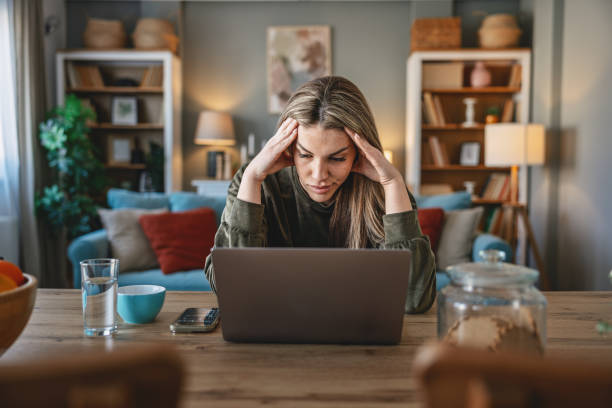 istock Female business person using digital tablet and laptop e-learning or remote working at home 2201454279