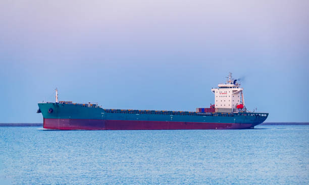 Container ship on the blue sea full load container for logistics, import export, shipping or transportation.
