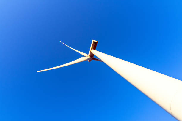 istock Wind turbine perspective against a vibrant blue sky 2201461414