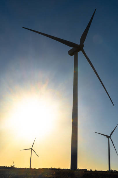 istock Wind turbine silhouette against the sun at sunset 2201461599