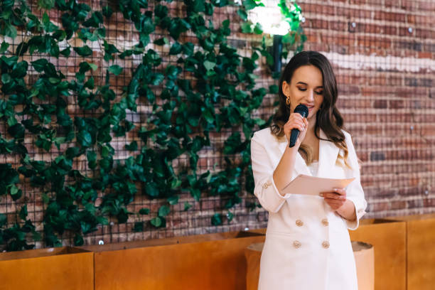 istock Master of ceremonies with microphone reads a speech 2201462146