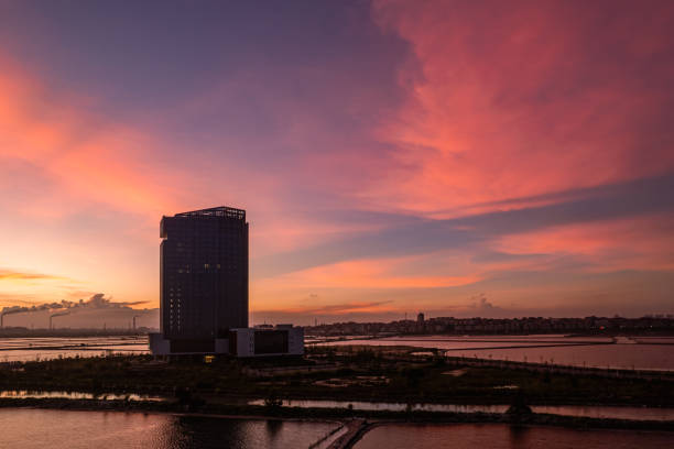 istock Tidal flat aquaculture ponds and buildings under the red sunset 2201467997