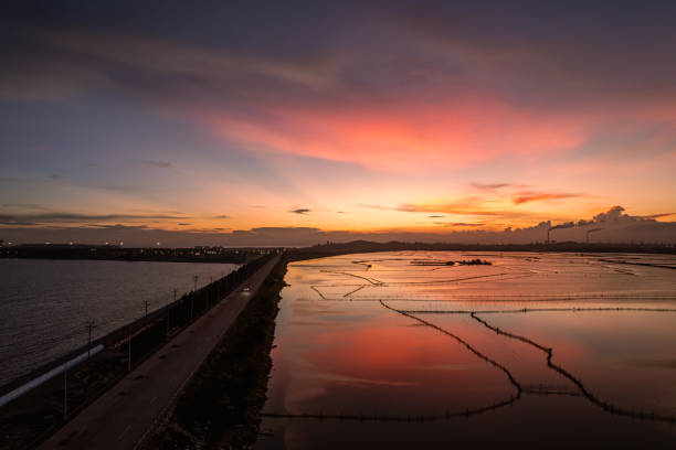 Tidal flat aquaculture pond under the red sunset