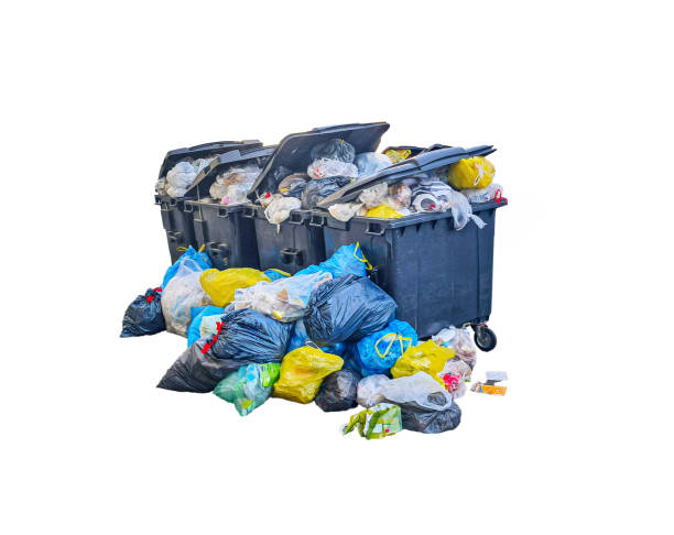 istock Overflowing trash cans with scattered garbage bags on a white background, garbage disposal problems, overloaded waste collection system, and environmental pollution 2201469699