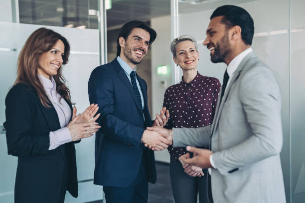 istock Business persons shaking hands across the table 2201469905