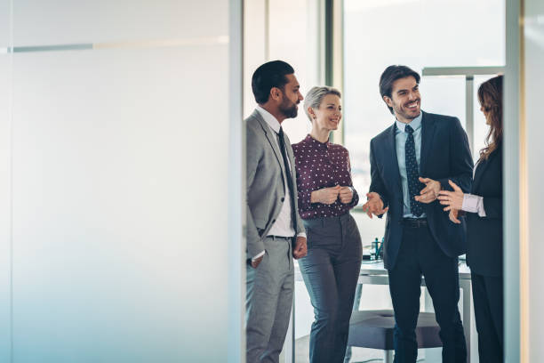 istock View through an open office door to a business team having a conversation 2201469907