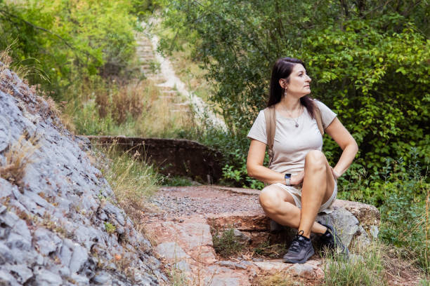 istock Connecting with nature. Woman backpacker exploring forest.  Precious moments while enjoying her adventure in parkland. 2201470171