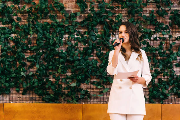 wedding ceremony. Master of ceremonies with microphone and photo
