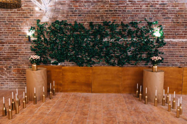 istock Wedding reception. brick wall with green leaves and flowers with 2201470276