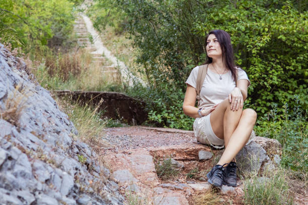 istock Connecting with nature. Woman backpacker exploring forest.  Precious moments while enjoying her adventure in parkland. 2201470873