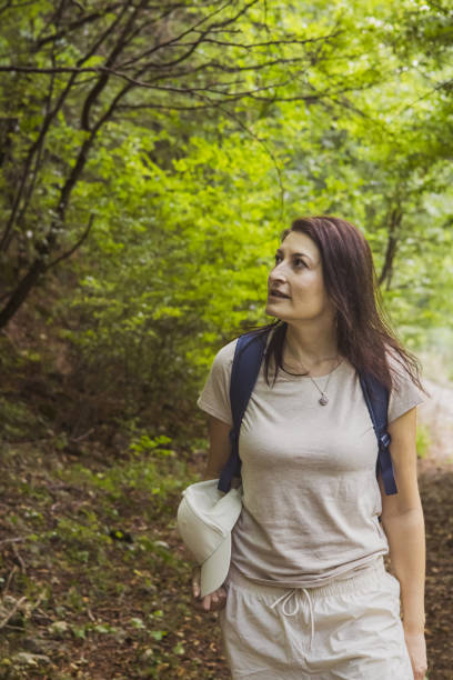 istock Connecting with nature. Woman backpacker exploring forest.  Precious moments while enjoying her adventure in parkland. 2201471809