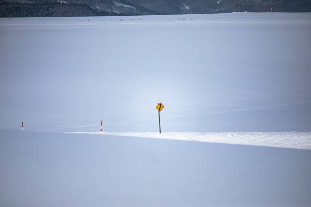 Driving on snow and snowy roads in winter traffic lights blizzard cars on icy street