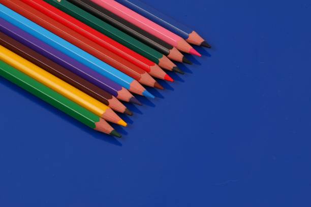 istock close up of various colored pencils lie in a row on a blue background 2201472741