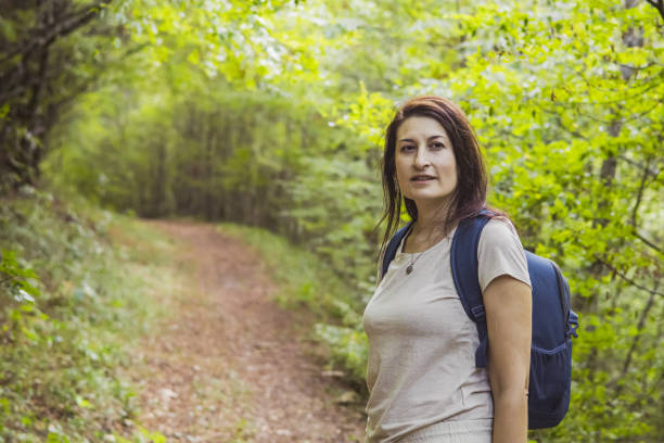 istock Connecting with nature. Woman backpacker exploring forest.  Precious moments while enjoying her adventure in parkland. 2201472959