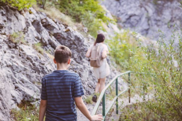 istock Connecting with nature. Mother and son exploring forest.  Precious family moments while enjoying their adventure in parkland. 2201473629