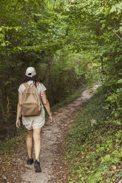 istock Connecting with nature. Woman backpacker exploring forest.  Precious moments while enjoying her adventure in parkland. Woman has diabetes and she is wearing small sensor on the back of upper arm for controlling blood sugar. Travel with chronic illness. 2201474170