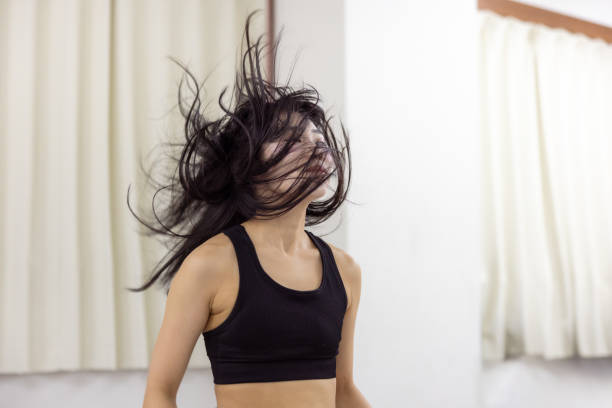 istock Female athlete dancing in dance studio - hair toss 2201477487