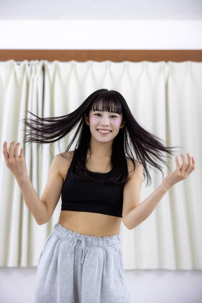 istock Female athlete dancing in dance studio - hair toss 2201477595