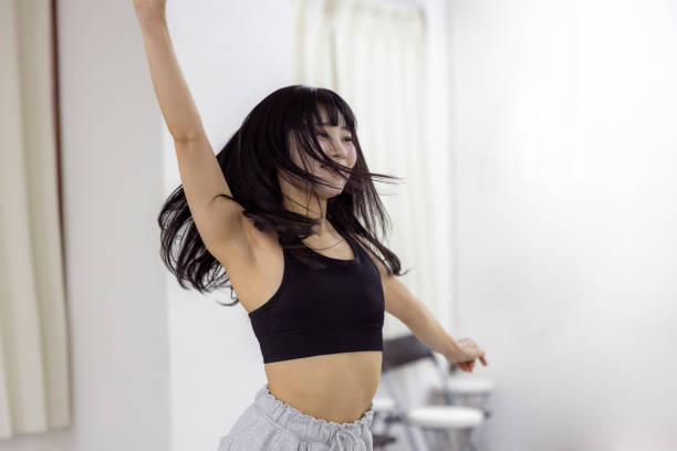 istock Female athlete dancing in dance studio - hand raised 2201477615