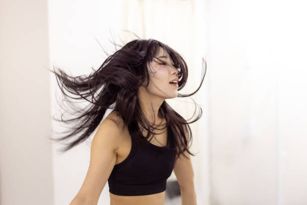 istock Female athlete dancing in dance studio - hair toss 2201477729