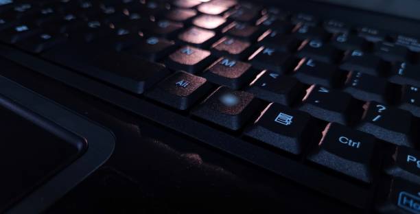 istock Close-up of computer keyboard in dark background. 2201479469