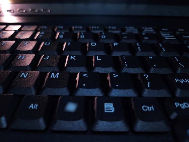 istock Close-up of computer keyboard in dark background. 2201479487